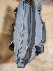 A Sophisticated Grey Handbag With Two Handles