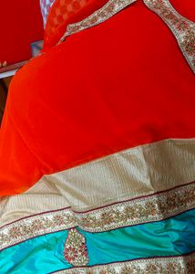 Orange Saree With Turquoise And GoldenBorder