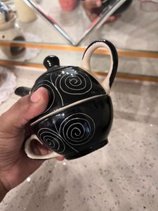 ceramic tea cup and kettle