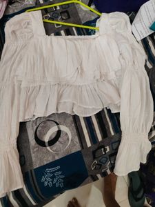 white bell bottom sleeves top.