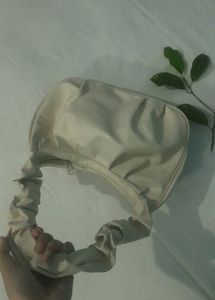 A Beige Side Bag.
