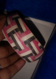 black breslet and a multi colour bangle