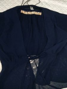 Elegant Blue Top with Embellished Neckline
