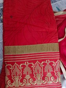 Red stitched women suit with pants and dupatta.