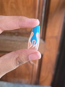Blue Flame with Nude Nail Extensions