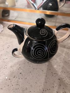 ceramic tea cup and kettle