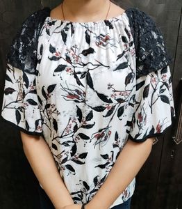 An Elegant White Off Shoulder Top