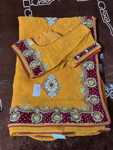 heavy work yellow red velvet border saree with blo