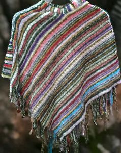 a colorful, striped poncho-style shawl with fringe