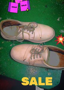 Worn White Lace-Up Shoes