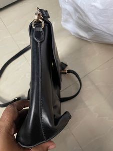 Black Sling Bag From Ajio. This Sling Is Sturdy and Useful For Keeping A Small Purse Along With Two Phones And Other Small Items. Bag Has 5 Compartments.