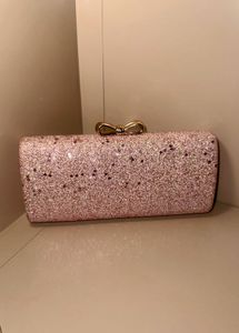 rose‑gold glitter box clutch with bow clasp, chain
