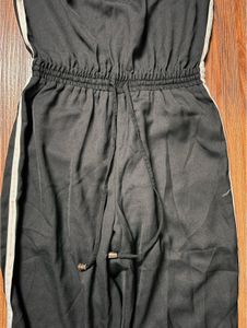 This sleek and stylish off-shoulder tube jumpsuit