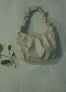 A Beige Side Bag.