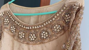 A golden mirror work on jorget suit . with neck work and sleeves fully work completed with salvar and dupatta