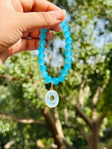 Light Blue Glass Beads Bracelet With Hanging Charm.