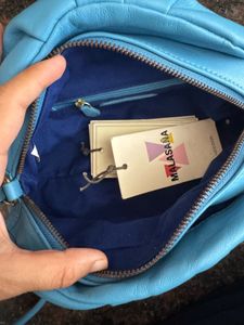 Hidesign sling with leather charm n dust bag