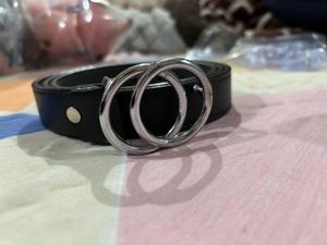 A black belt with silver buckle