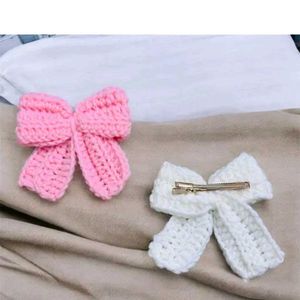 Pink and white wool bow hair clip for woman