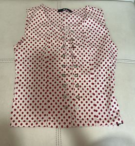 white top with red polka dots