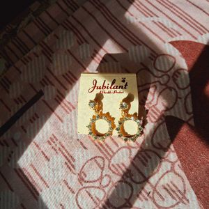 White stoned gold plated earrings