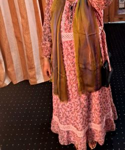 A pink floral gown with white lace trim