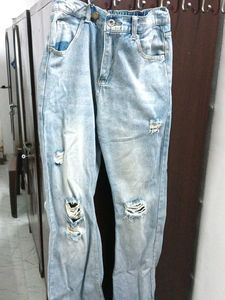 A ripped blue denim jeans