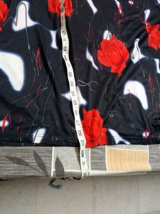 smart black top with red flowers on it