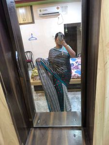 Green,red,black and white standard saree.