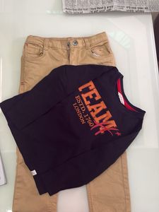 one black T-shirt with beige trousers