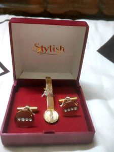 golden cufflinks and tie-pin