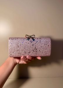 rose‑gold glitter box clutch with bow clasp, chain