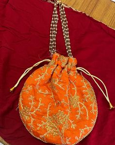 Handcrafted Orange Potli Bag with Intricate Gold