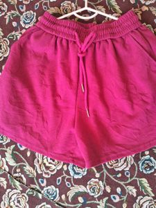 A pair of fuchsia shorts with  drawstring waist