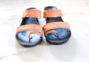 Sandal with a combination of peach and black colou