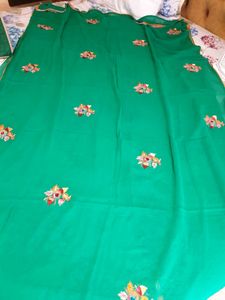 Pure georgette saree in green color  embroidered flower  ?
