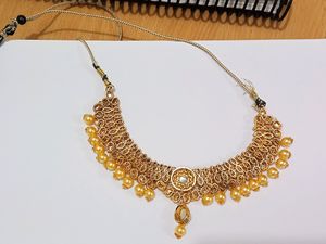 A Diamond Necklace Set With Earnings And Mangtika