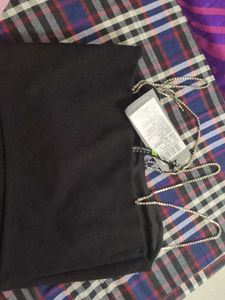 A Black Top With Stones Straps