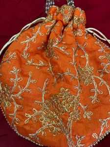 Handcrafted Orange Potli Bag with Intricate Gold