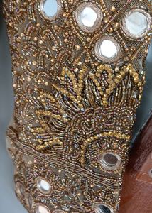A golden mirror work on jorget suit . with neck work and sleeves fully work completed with salvar and dupatta