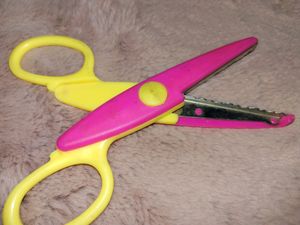 A scissor for cutting Designed Border of paper