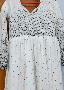 White frock with black dots design..