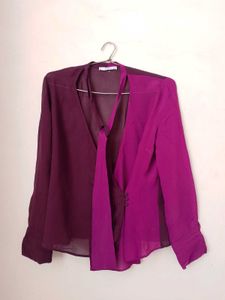 Branded two- tone wrap top.