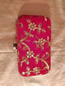 red clutch with zari work