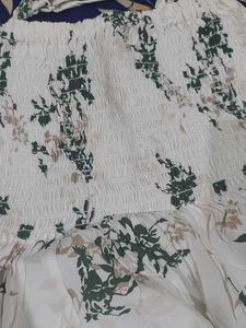 a white body fitted top in flower pattern