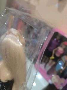 Hannah doll in black dress with long hair.