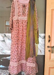 A pink floral gown with white lace trim