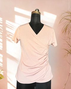 Pink shimmer top with ruching details on the waist