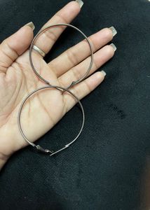large silver-toned hoop earrings.