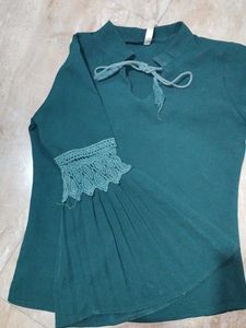 A dark green , full sleeve top